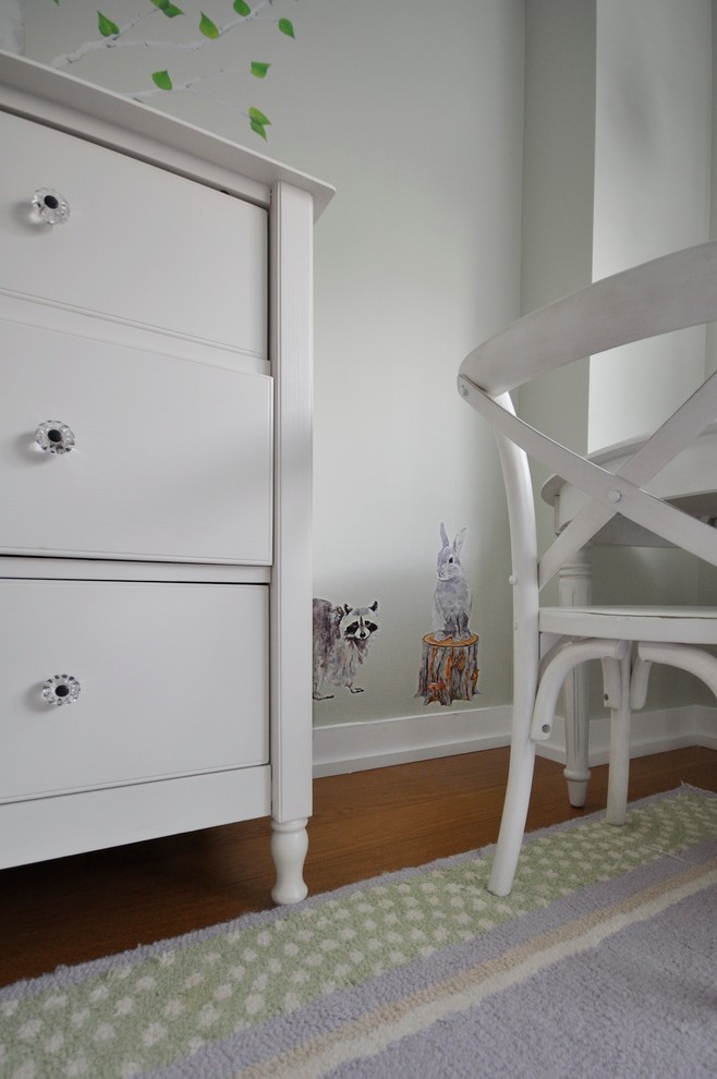 Photo of a medium sized traditional children’s room for girls in New York with white walls and medium hardwood flooring.
