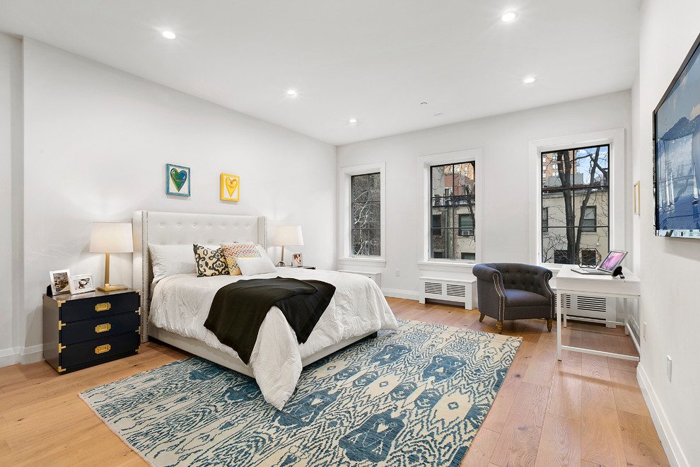 This is an example of a traditional teen’s room for girls in New York with white walls and medium hardwood flooring.
