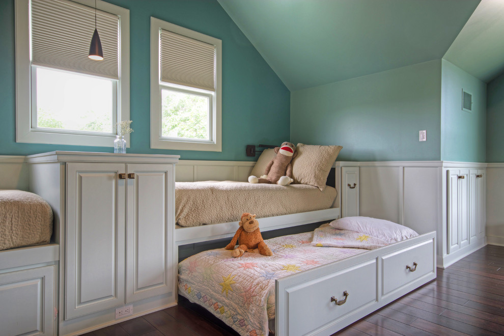 Traditional gender neutral children’s room in Austin with blue walls and dark hardwood flooring.
