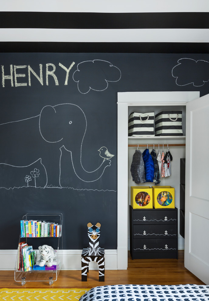 Photo of a small contemporary toddler’s room for boys in Chicago with grey walls and light hardwood flooring.