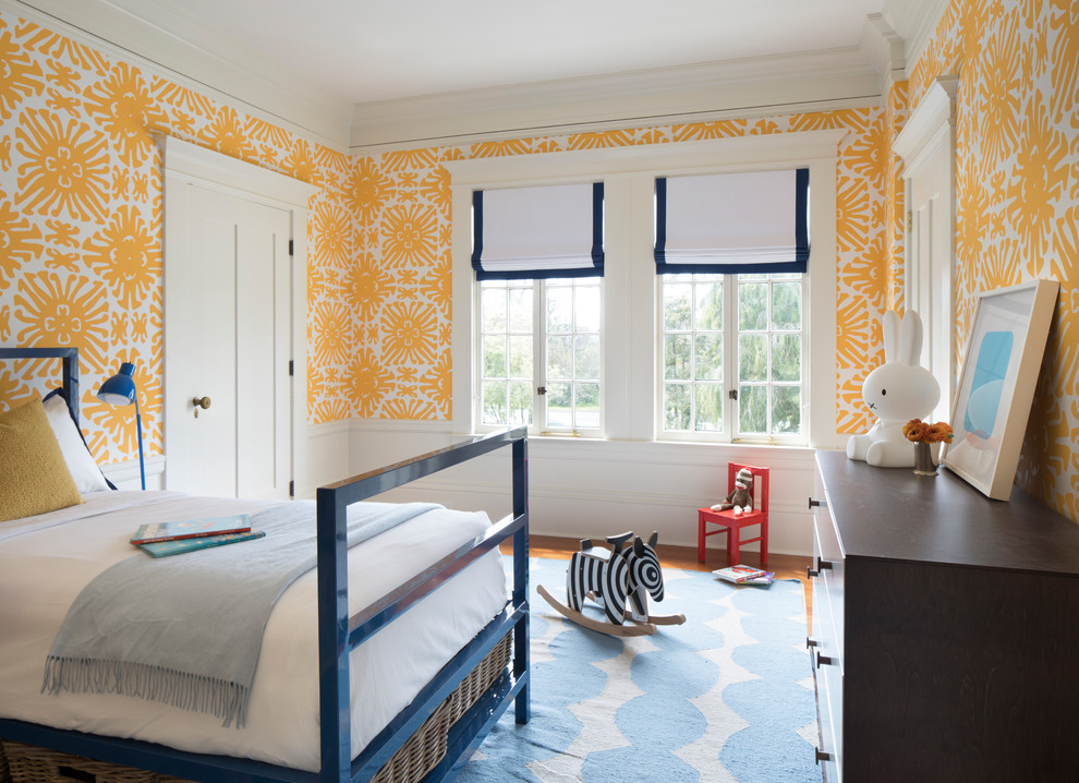 This is an example of a classic kids' bedroom in San Francisco with yellow walls, medium hardwood flooring and brown floors.
