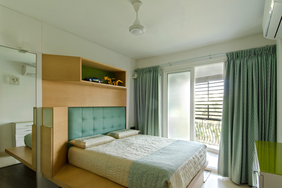 This is an example of a small contemporary teen’s room for boys in Bengaluru with white walls.