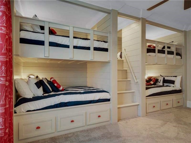 Design ideas for a large nautical gender neutral children’s room in Other with beige walls, carpet and beige floors.
