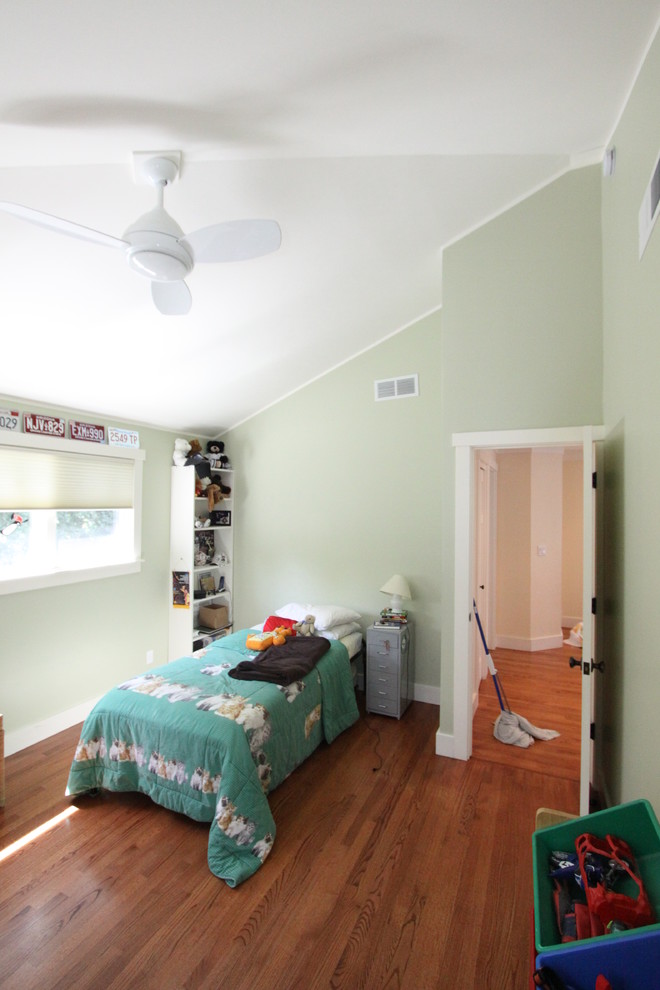 Elegant medium tone wood floor kids' bedroom photo in Charlotte with green walls