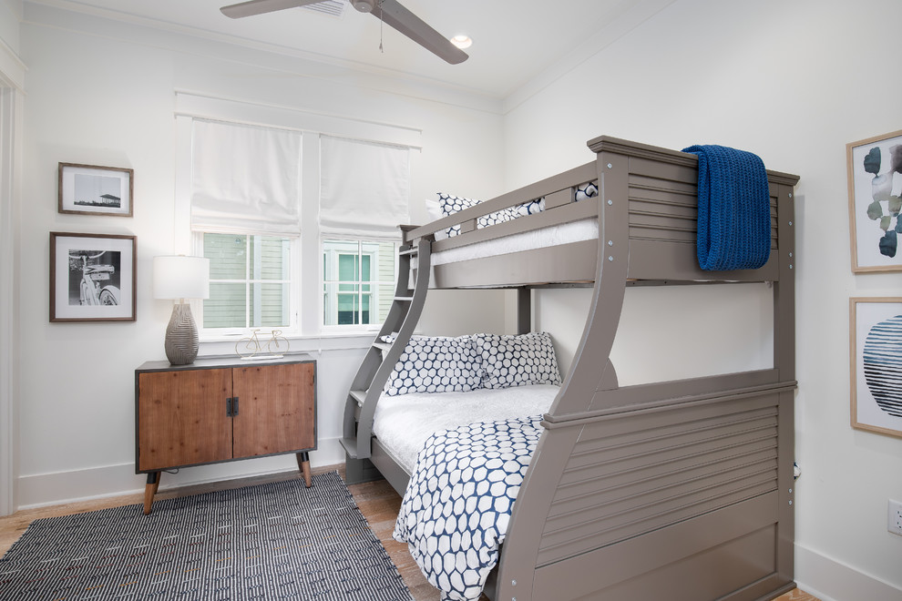 Réalisation d'une chambre d'enfant marine avec un mur blanc, parquet clair et un lit superposé.