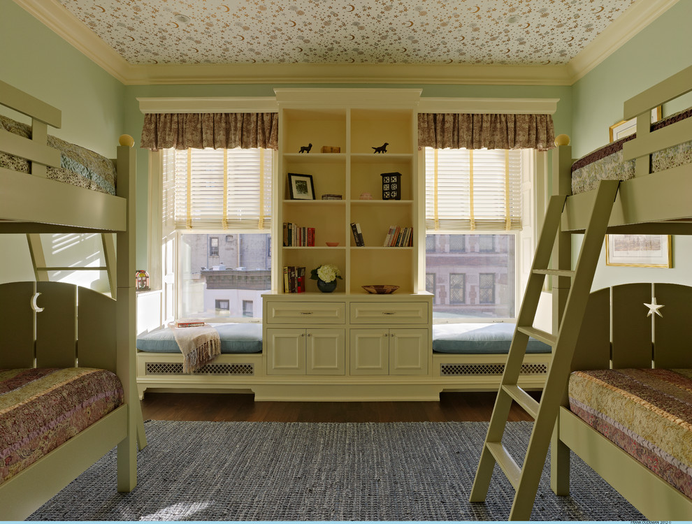 This is an example of a medium sized traditional children’s room in New York with green walls, dark hardwood flooring and brown floors.