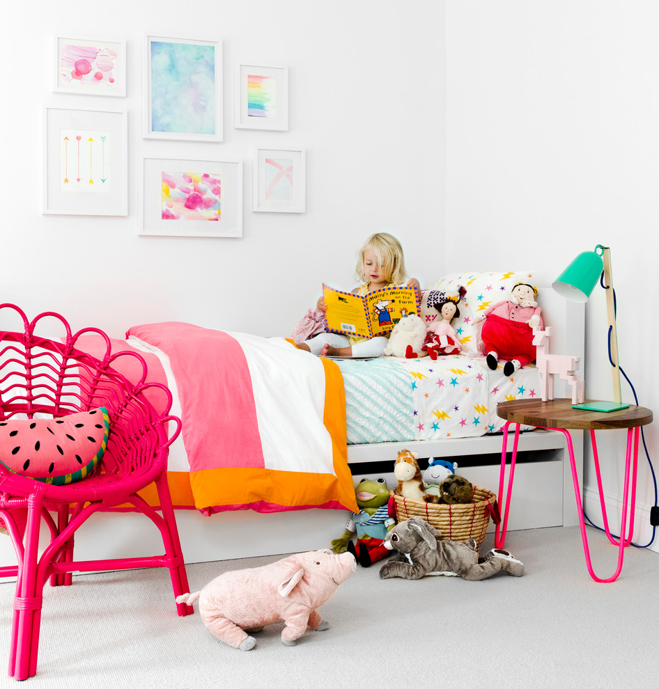 Inspiration for a contemporary children’s room for girls in New York with white walls and carpet.