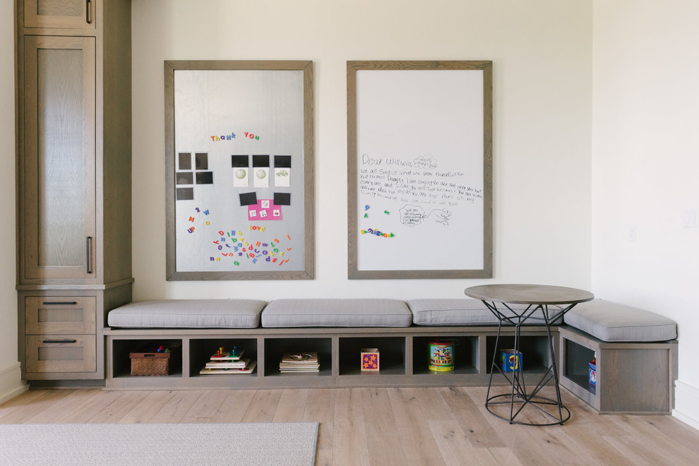 This is an example of a large classic gender neutral kids' bedroom in Austin with white walls, light hardwood flooring and beige floors.