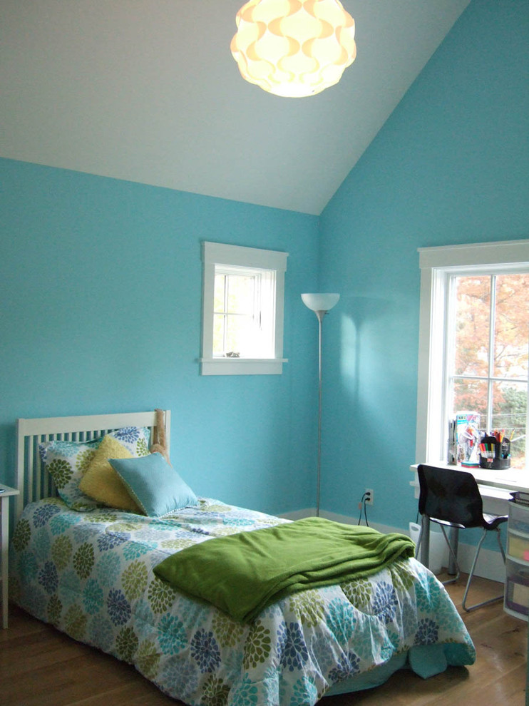 Medium sized farmhouse teen’s room for girls in New York with blue walls and light hardwood flooring.