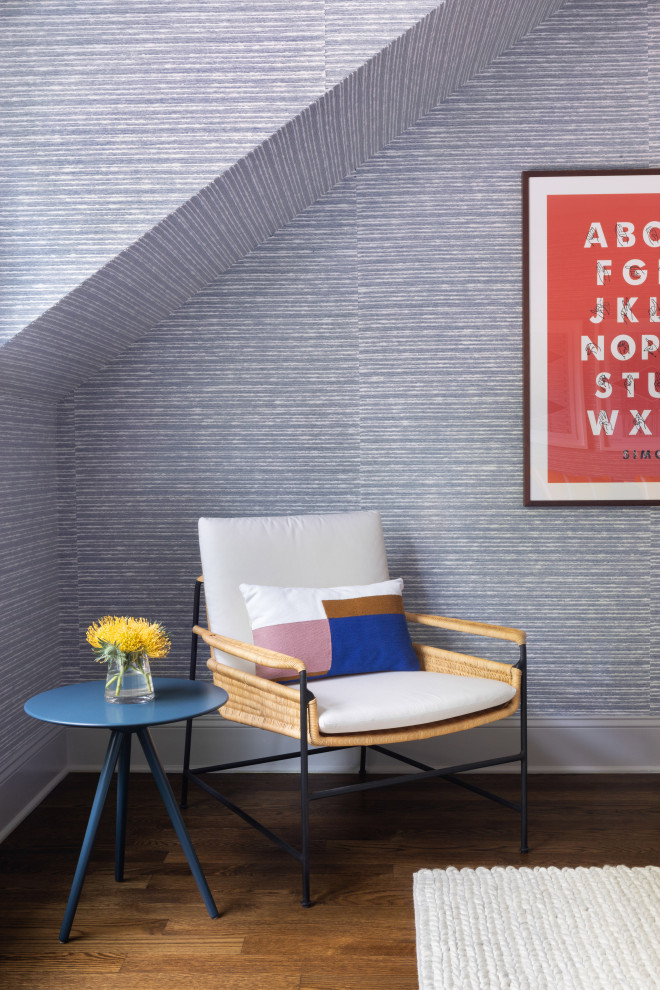 Large traditional children’s room for boys in New York with blue walls, dark hardwood flooring and brown floors.