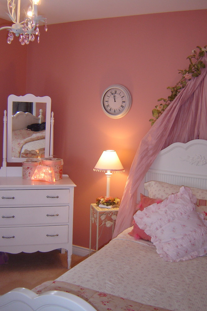This is an example of a traditional children’s room for girls in Other with pink walls.