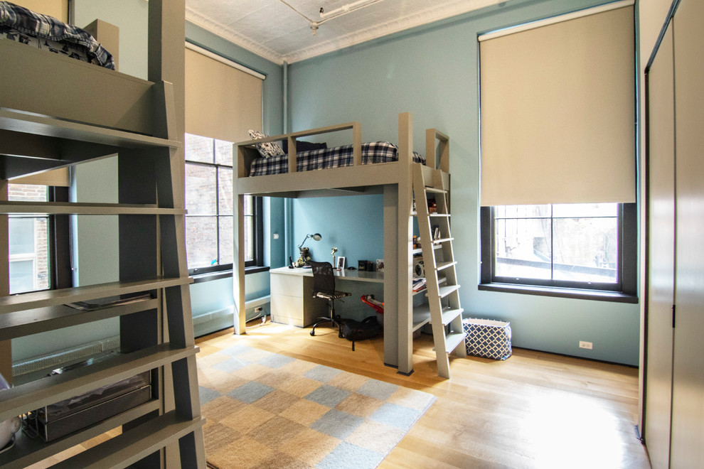 Design ideas for a large urban kids' bedroom in New York with blue walls, light hardwood flooring and brown floors.