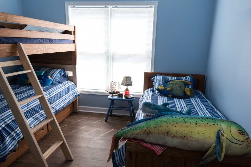 Immagine di una piccola cameretta per bambini da 4 a 10 anni stile marinaro con pareti blu e pavimento in vinile