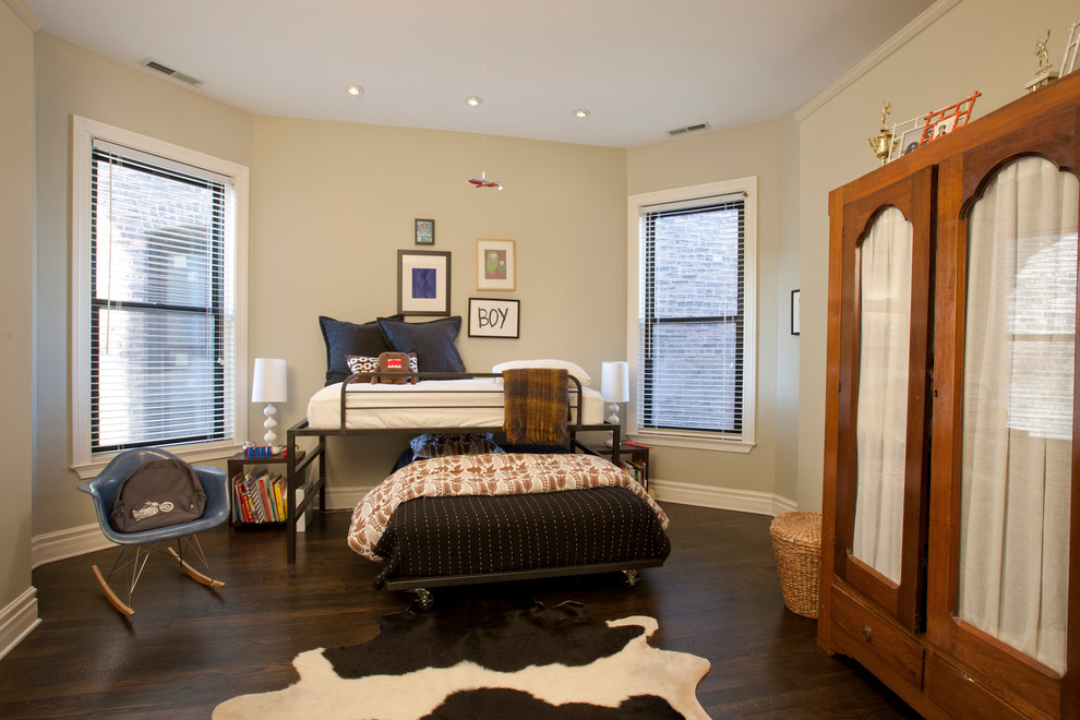 Classic children’s room for boys in Chicago with beige walls, dark hardwood flooring and brown floors.