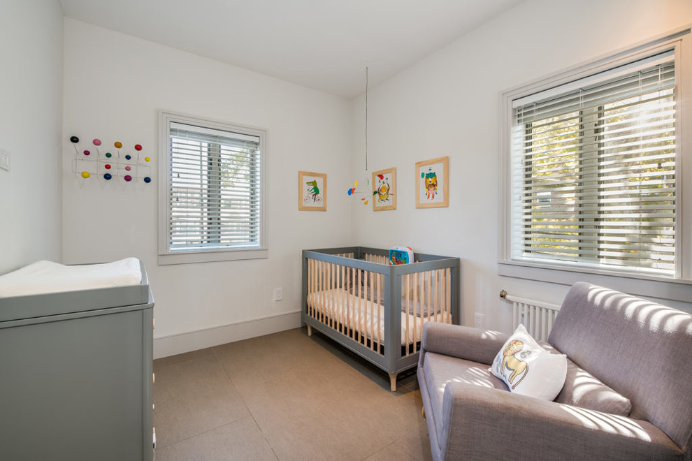 Imagen de habitación de bebé niño minimalista pequeña con paredes blancas, suelo de baldosas de porcelana y suelo gris