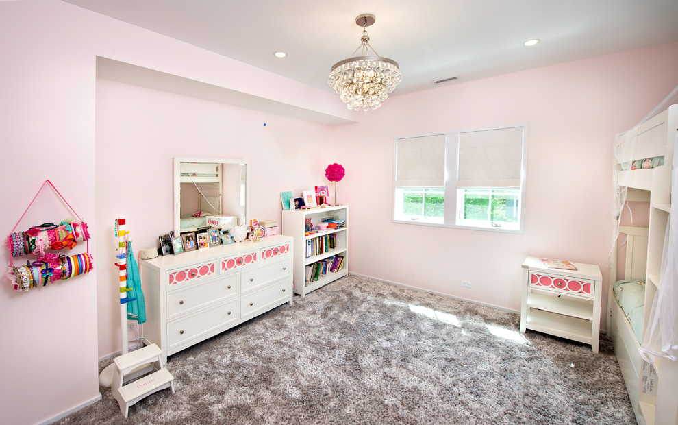 Example of a mid-sized minimalist girl carpeted and gray floor kids' room design in Chicago with pink walls