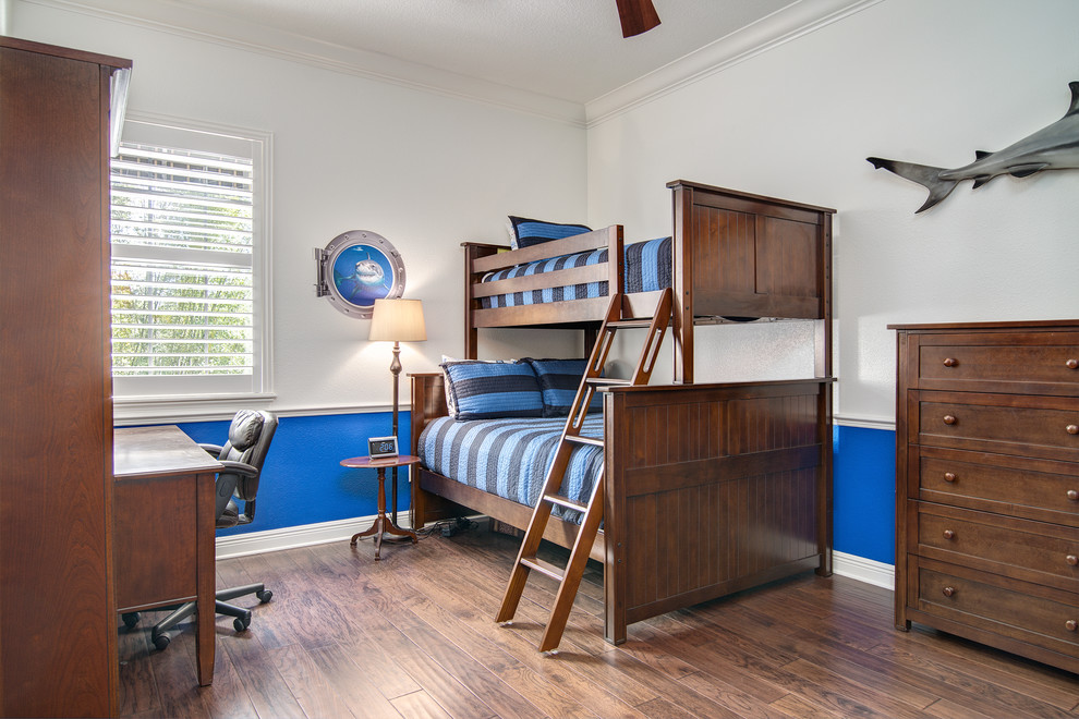 This is an example of a classic children’s room for boys in Orlando with multi-coloured walls and medium hardwood flooring.