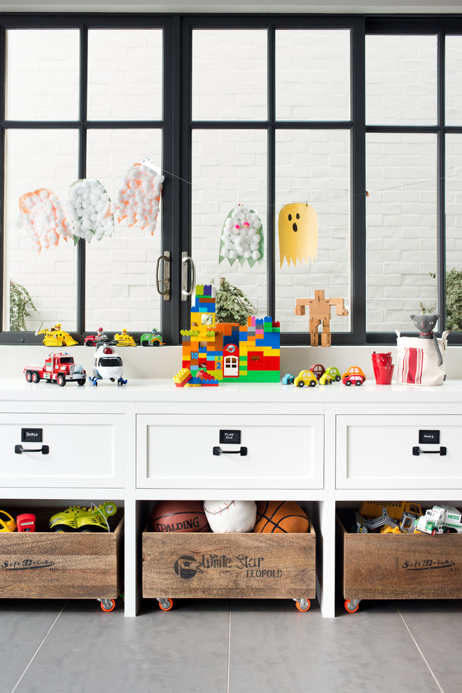 Design ideas for a traditional gender neutral playroom in Los Angeles with grey floors.