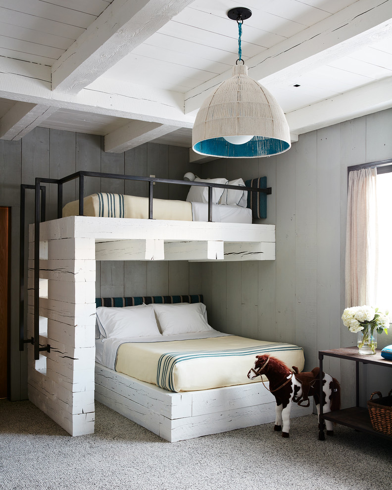 This is an example of a rustic gender neutral kids' bedroom in Other with grey walls, carpet and grey floors.