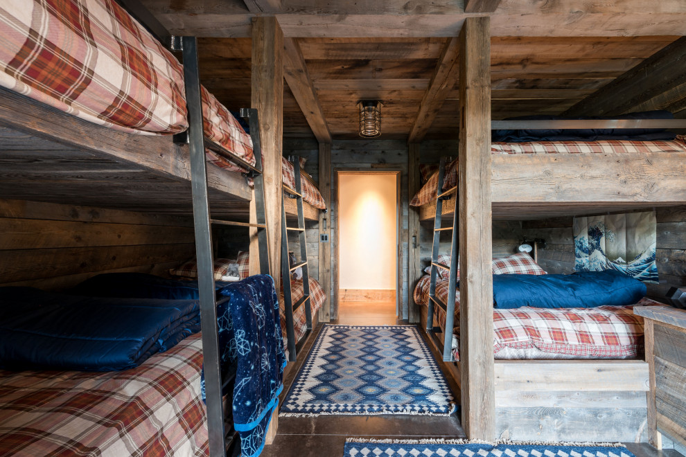 Idee per una cameretta da letto rustica con pareti marroni, pavimento in cemento e pavimento nero