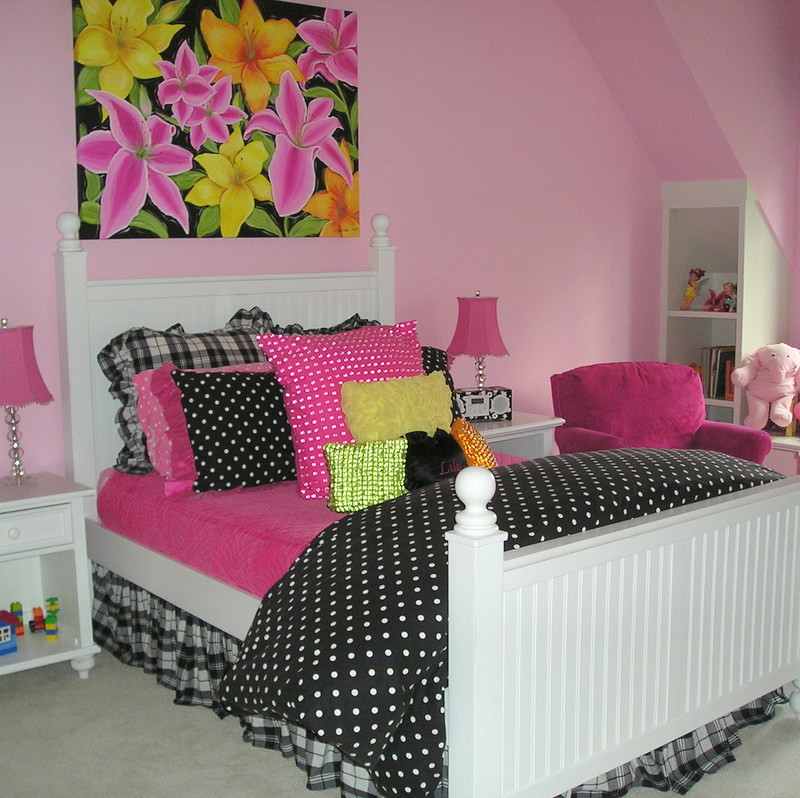 Example of a mid-sized transitional girl carpeted kids' room design in Chicago with pink walls