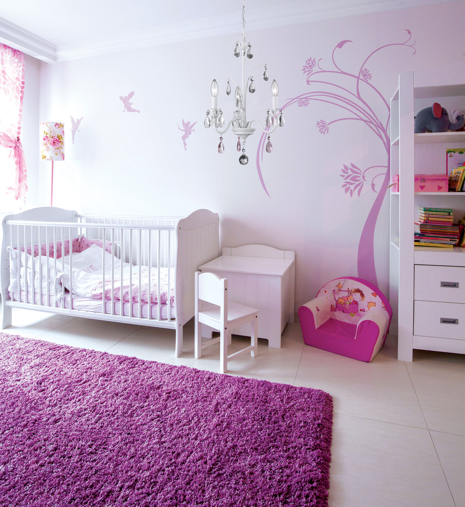 This is an example of a medium sized contemporary toddler’s room for girls in Toronto with white walls and carpet.