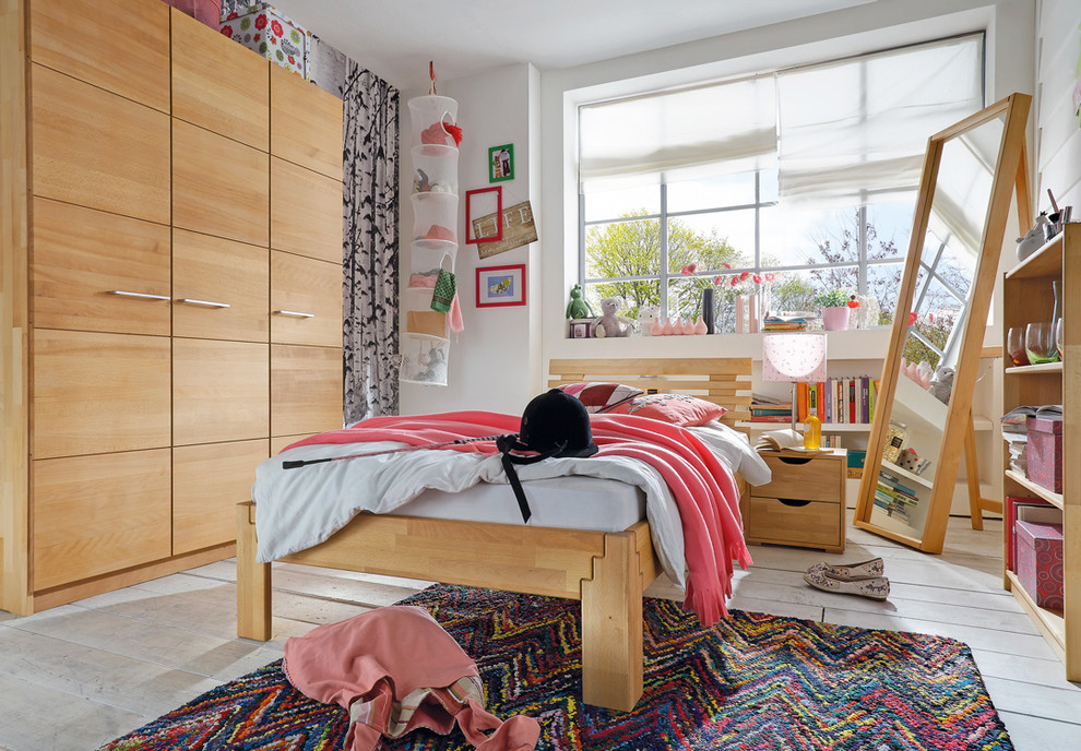 Medium sized contemporary teen’s room for girls in Bonn with white walls and painted wood flooring.