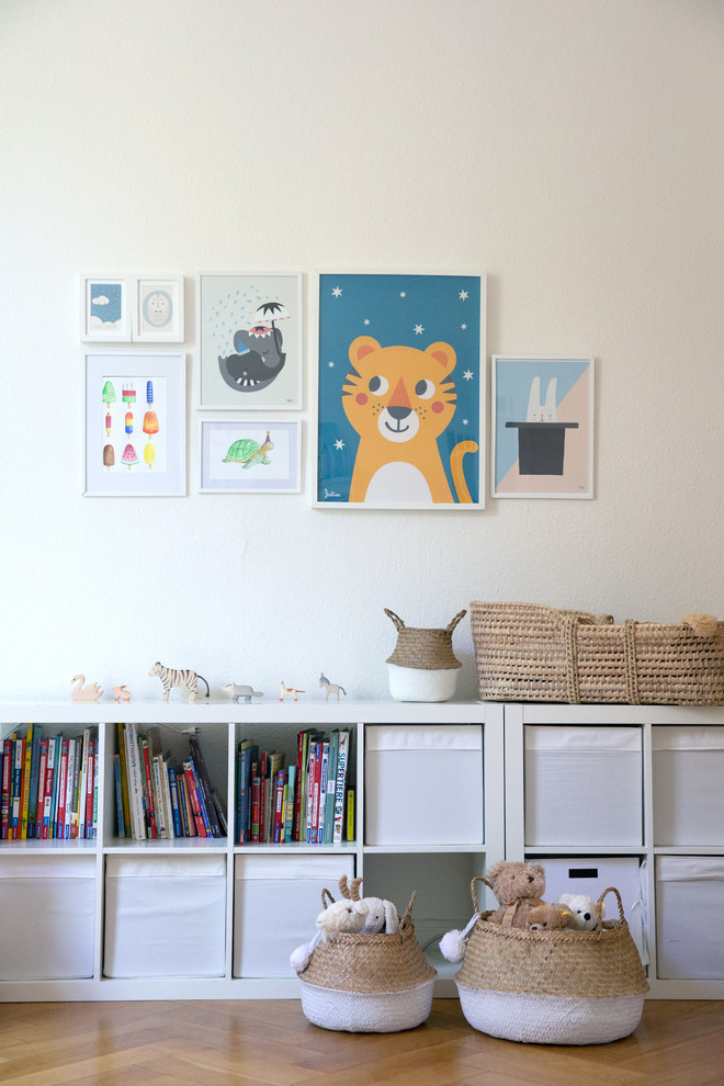 This is an example of a large scandi kids' bedroom for boys in Hamburg with white walls, medium hardwood flooring and beige floors.