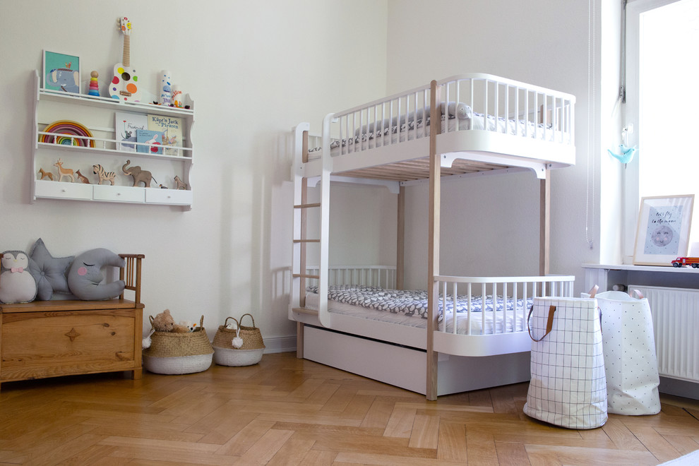Imagen de dormitorio infantil de 4 a 10 años nórdico grande con paredes blancas, suelo de madera en tonos medios y suelo beige