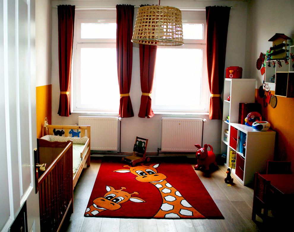 Mittelgroßes, Neutrales Modernes Kinderzimmer mit Spielecke, weißer Wandfarbe, Laminat und braunem Boden in Berlin
