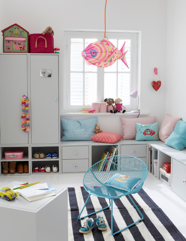 Inspiration för mellanstora moderna könsneutrala småbarnsrum kombinerat med lekrum, med vita väggar och målat trägolv
