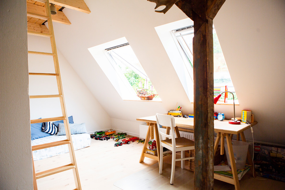 Idée de décoration pour une petite chambre de garçon de 4 à 10 ans nordique avec un mur blanc et parquet clair.