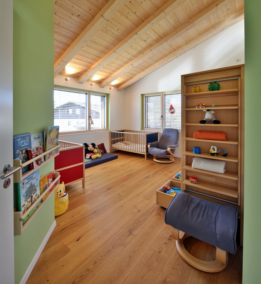 Esempio di una cameretta per bambini da 4 a 10 anni di medie dimensioni con pareti bianche, parquet chiaro e soffitto in legno