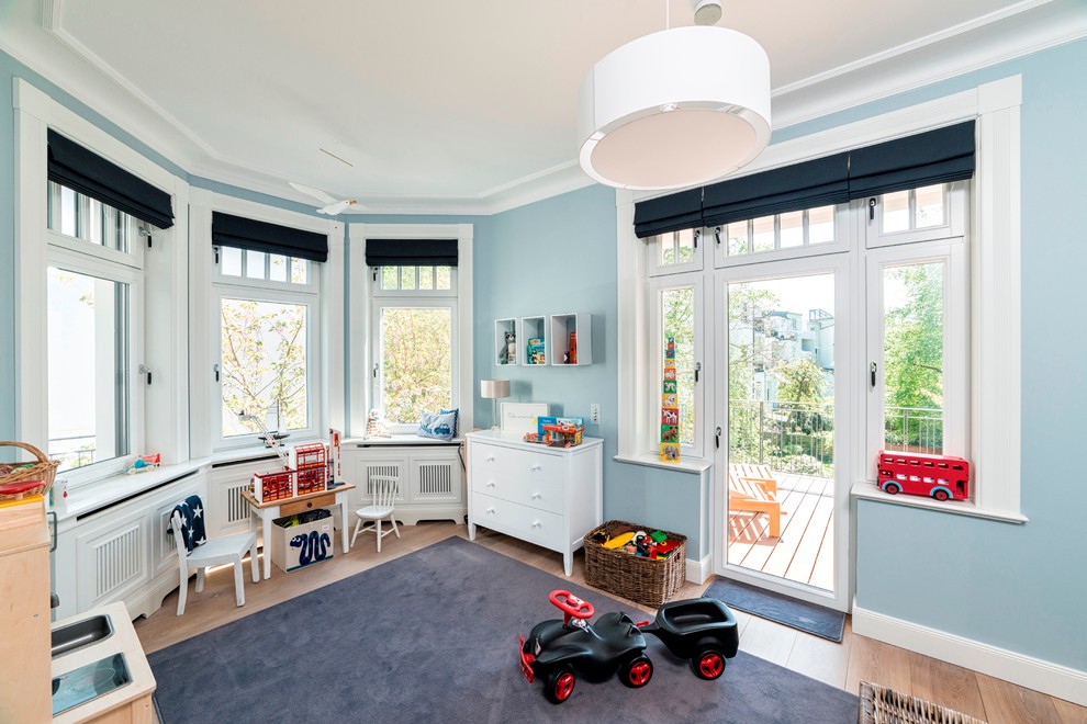 На фото: большая детская с игровой в классическом стиле с синими стенами и светлым паркетным полом для ребенка от 1 до 3 лет, мальчика с
