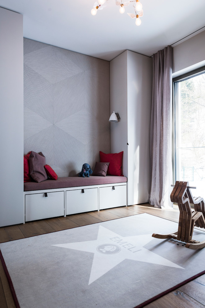 Inspiration for a mid-sized contemporary gender-neutral dark wood floor kids' room remodel in Munich with gray walls
