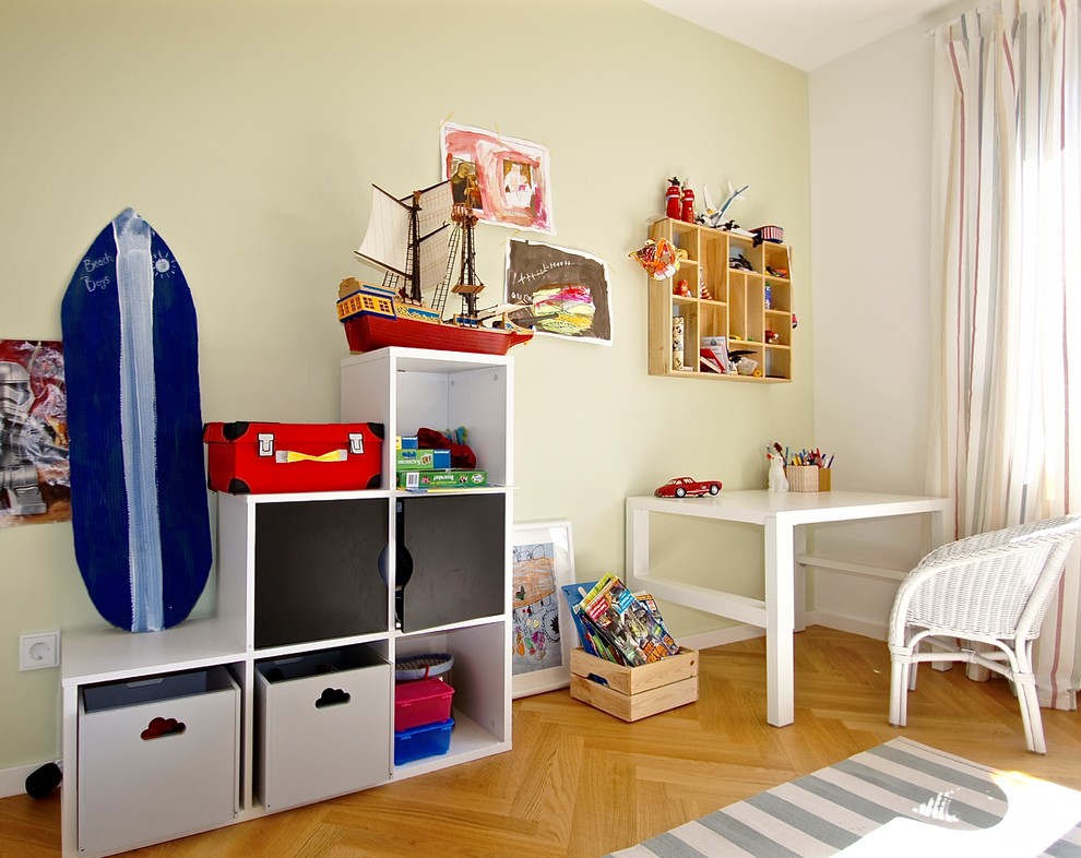 Inspiration for a medium sized contemporary kids' bedroom for boys in Munich with medium hardwood flooring, brown floors and green walls.