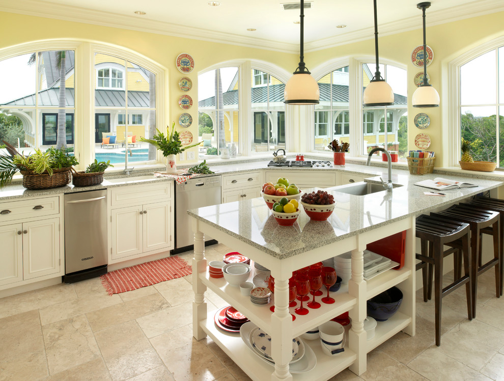 Example of an island style beige floor kitchen design in Boston with an undermount sink, white cabinets, stainless steel appliances, granite countertops and gray countertops