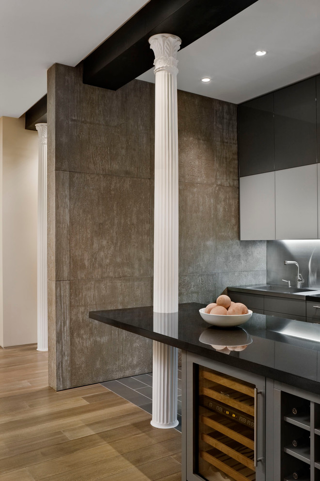 Kitchen - contemporary kitchen idea in New York with flat-panel cabinets and metallic backsplash