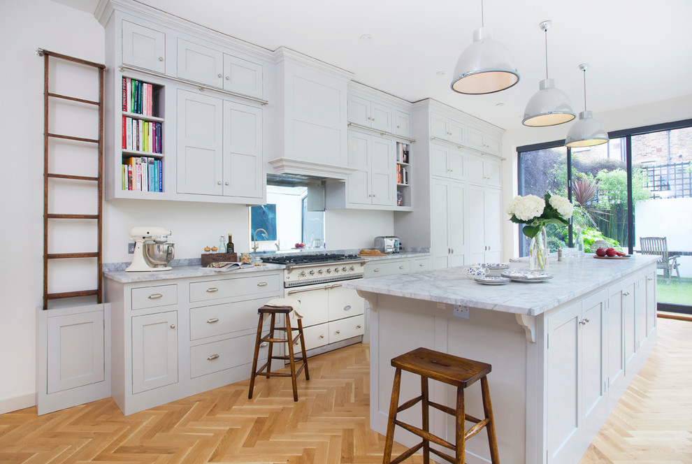 Photo of a classic kitchen in Surrey with shaker cabinets and an island.