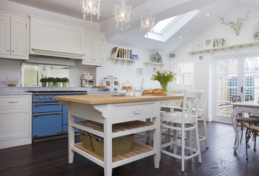 Farmhouse kitchen photo in Surrey with shaker cabinets and an island