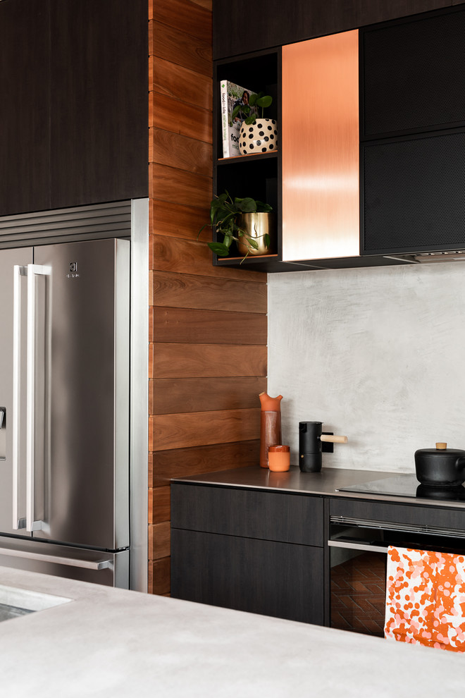 This is an example of a large urban galley enclosed kitchen in Perth with a submerged sink, flat-panel cabinets, dark wood cabinets, concrete worktops, grey splashback, stainless steel appliances, brick flooring, an island, red floors and grey worktops.
