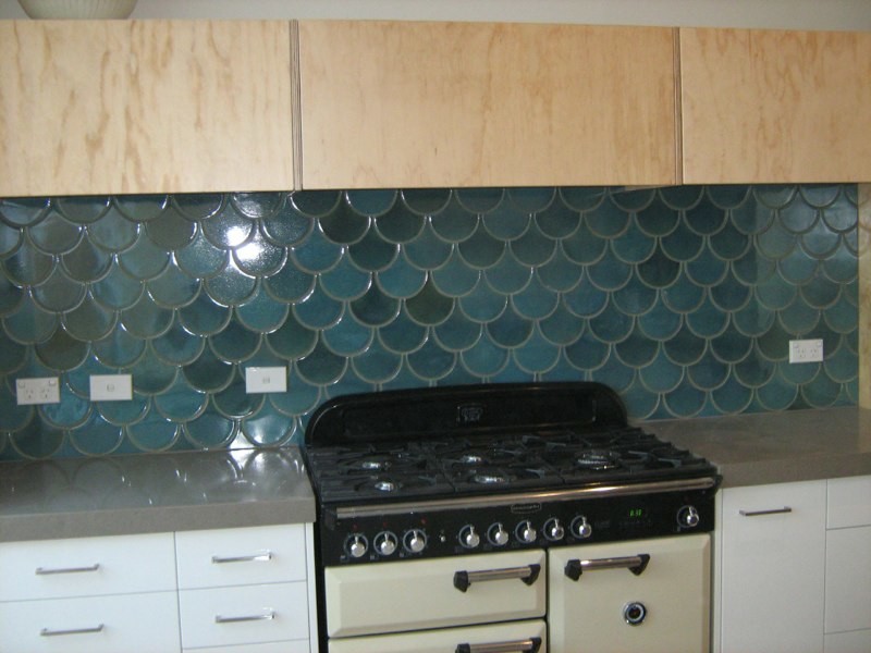 Photo of a mediterranean kitchen in Brisbane with blue splashback and porcelain splashback.