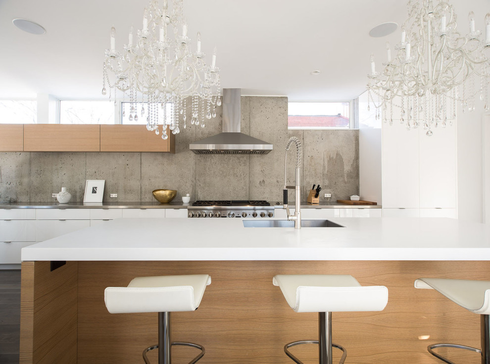 Inspiration for a modern l-shaped kitchen in Minneapolis with a single-bowl sink, flat-panel cabinets, white cabinets, engineered stone countertops, beige splashback, stainless steel appliances and an island.