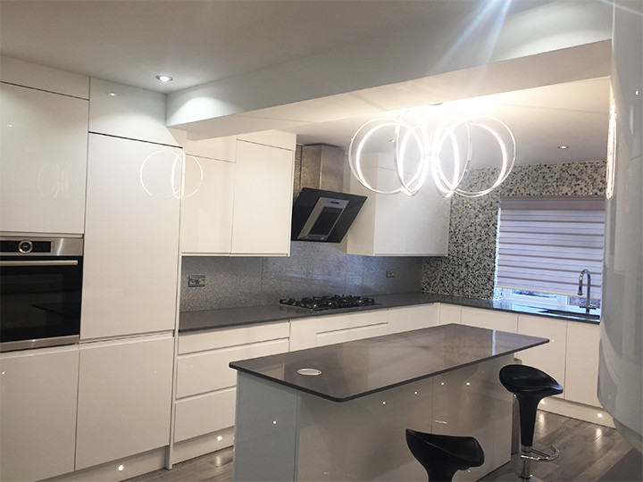Idee per una grande cucina abitabile minimalista con ante lisce, ante bianche, top in marmo, paraspruzzi grigio, paraspruzzi con lastra di vetro e nessuna isola