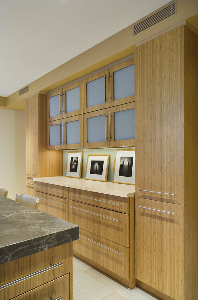This is an example of a contemporary kitchen in New York with flat-panel cabinets and medium wood cabinets.