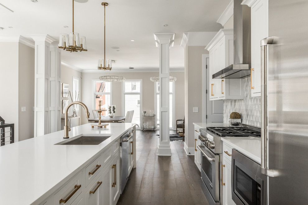 Inspiration for a large transitional galley medium tone wood floor and brown floor open concept kitchen remodel in Indianapolis with an undermount sink, medium tone wood cabinets, quartzite countertops, gray backsplash, marble backsplash, stainless steel appliances, an island and recessed-panel cabinets