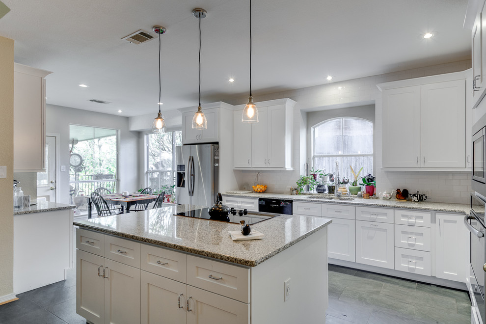 This is an example of a medium sized classic l-shaped kitchen/diner in Dallas with a submerged sink, shaker cabinets, white cabinets, granite worktops, white splashback, metro tiled splashback, stainless steel appliances, porcelain flooring and an island.