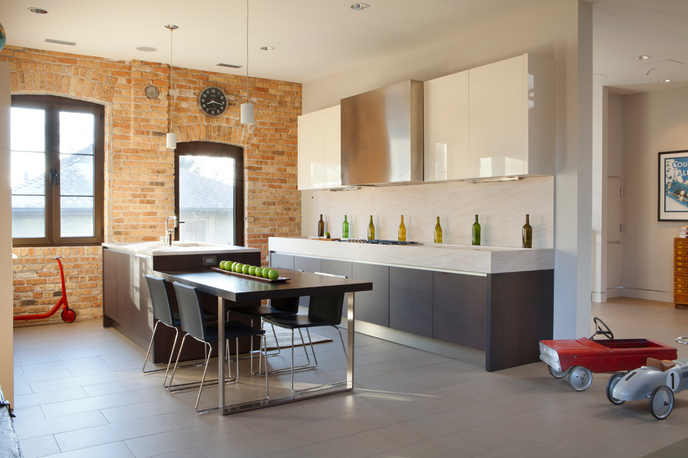 Photo of an urban galley kitchen/diner in Chicago with flat-panel cabinets, dark wood cabinets and beige splashback.