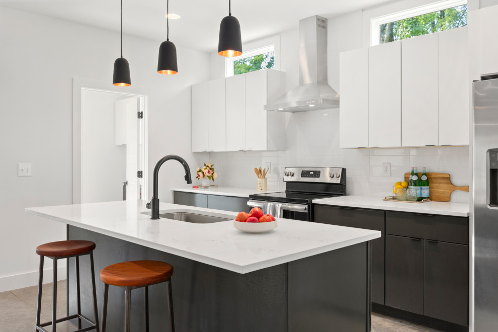 Design ideas for a contemporary kitchen in Nashville with a submerged sink, flat-panel cabinets, black cabinets, white splashback, an island, grey floors and white worktops.
