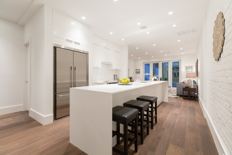Trendy open concept kitchen photo in DC Metro with flat-panel cabinets, white cabinets and stainless steel appliances